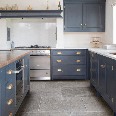 Grey kitchen tile in a navy blue kitchen with a steel 