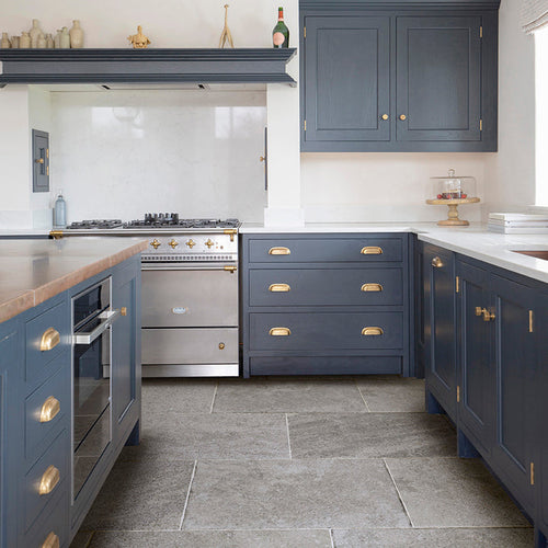 Grey kitchen tile in a navy blue kitchen with a steel 