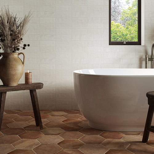 bathroom with a bath and terracotta hexagon tiles 
