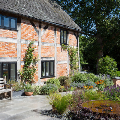 Step inside a cottage garden with Farrow Grey limestone paving