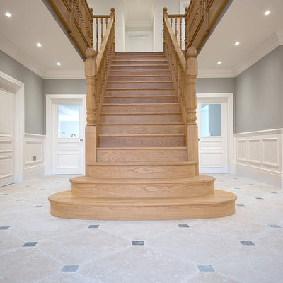hallway tiles with a grand staircase