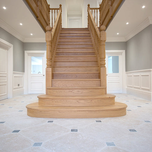 hallway tiles with a grand staircase