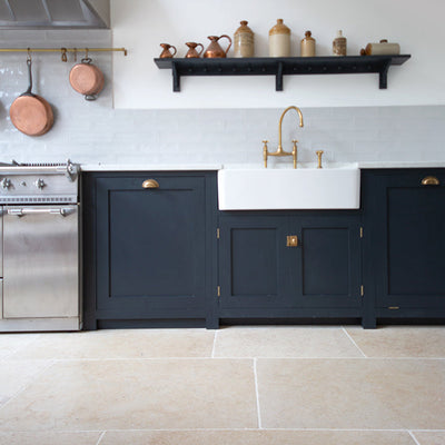 Monte Carlo floor with Blue units in a kitchen with copper hanging pans