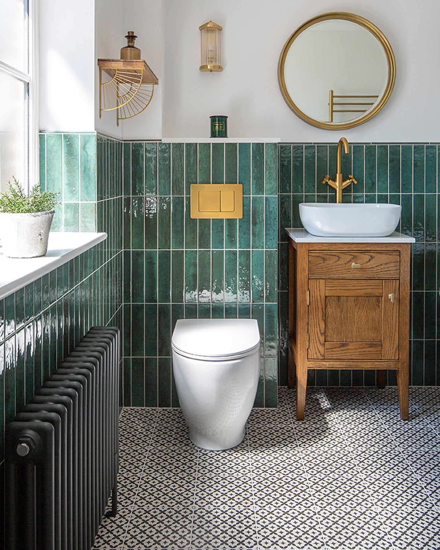 bathroom with green metro tiles and toilet with vanity sink 