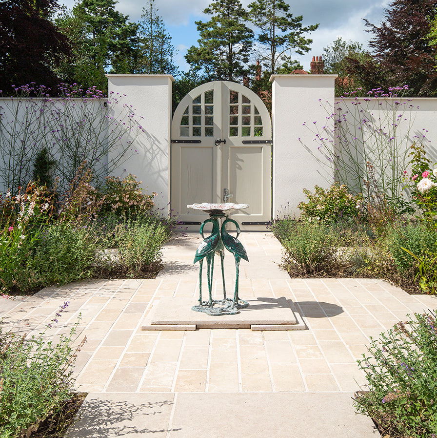 Paving with Dijon Tumbled and a statue in the middle leading to a garden 