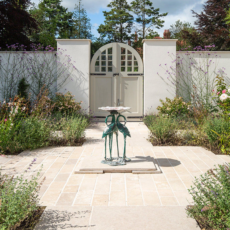 Paving with Dijon Tumbled and a statue in the middle leading to a garden 