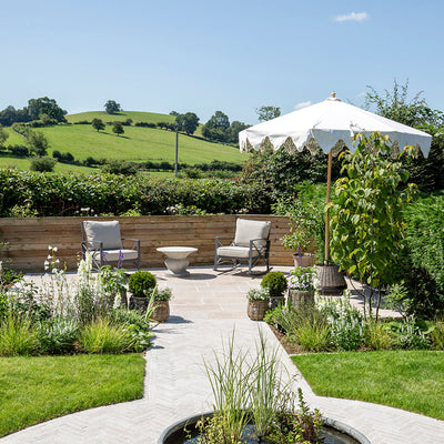 limestone patio overlooking green fields and sunloungers 